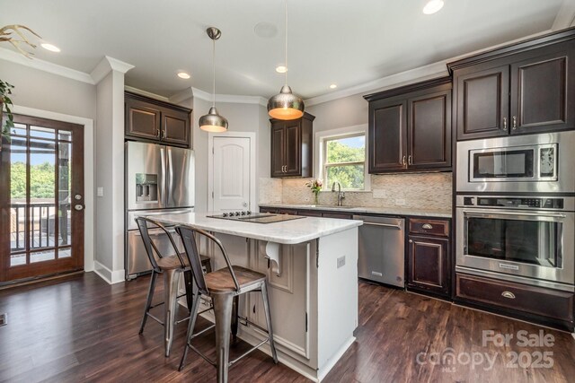 7805 Crooked Creek Church Rd, Monroe, NC 28110 - kitchen with stainless steel appliances, dark brown cabinetry, a kitchen bar, tasteful backsplash, and dark wood-style floors