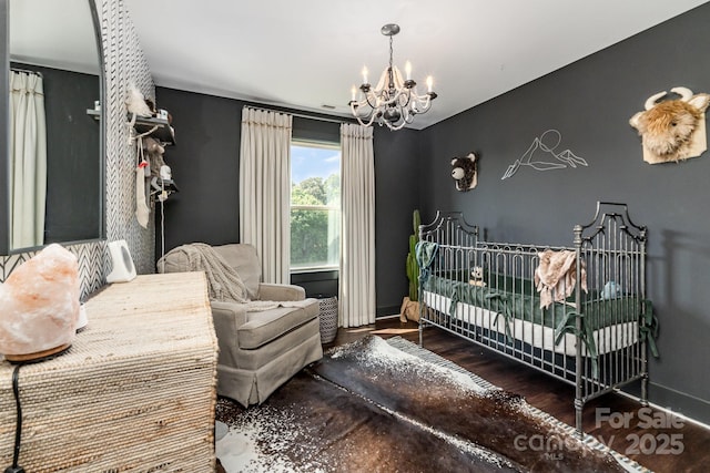 7805 Crooked Creek Church Rd, Monroe, NC 28110 - bedroom with a chandelier, a nursery area, and wood finished floors