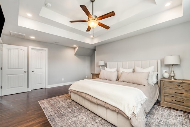 7805 Crooked Creek Church Rd, Monroe, NC 28110 - bedroom with a tray ceiling, dark wood-style flooring, recessed lighting, and a ceiling fan
