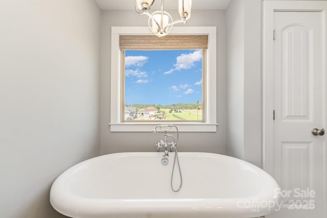7805 Crooked Creek Church Rd, Monroe, NC 28110 - bathroom featuring a freestanding tub and a chandelier