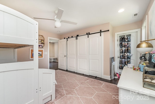 7805 Crooked Creek Church Rd, Monroe, NC 28110 - bedroom with a barn door, recessed lighting, and a ceiling fan