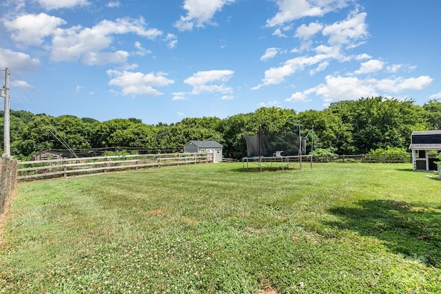 7805 Crooked Creek Church Rd, Monroe, NC 28110 - fenced backyard featuring a trampoline, a storage unit, and a rural view