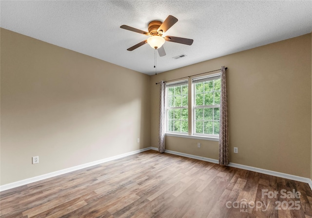 1326 Anthem Ct, Charlotte, NC 28205 - empty room with wood finished floors, ceiling fan, and a textured ceiling