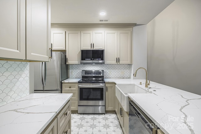 795 Peninsula Dr, Davidson, NC 28036 - kitchen with appliances with stainless steel finishes, tasteful backsplash, light floors, and light stone counters