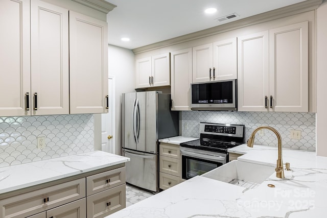 795 Peninsula Dr, Davidson, NC 28036 - kitchen featuring appliances with stainless steel finishes, light stone counters, decorative backsplash, and recessed lighting