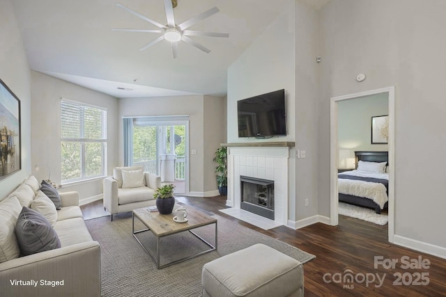 795 Peninsula Dr, Davidson, NC 28036 - living room featuring wood finished floors, a ceiling fan, high vaulted ceiling, and a tiled fireplace