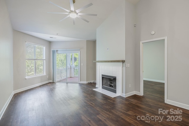795 Peninsula Dr, Davidson, NC 28036 - unfurnished living room featuring a ceiling fan, a tiled fireplace, high vaulted ceiling, and wood finished floors