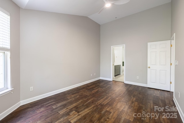 795 Peninsula Dr, Davidson, NC 28036 - unfurnished bedroom with multiple windows, dark wood finished floors, high vaulted ceiling, ensuite bath, and ceiling fan