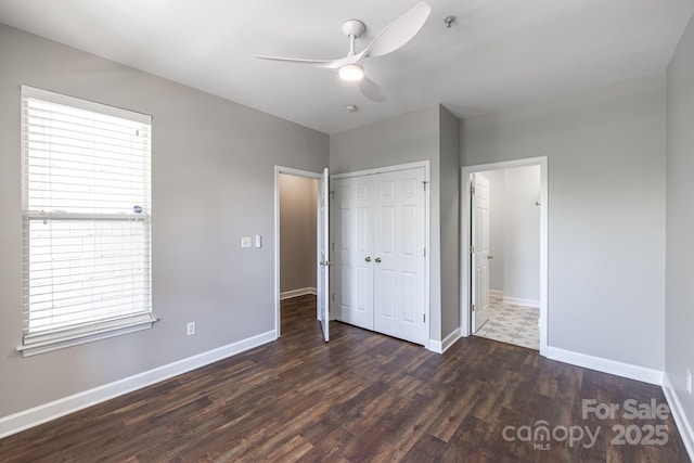 795 Peninsula Dr, Davidson, NC 28036 - unfurnished bedroom featuring wood finished floors, a closet, multiple windows, and a ceiling fan
