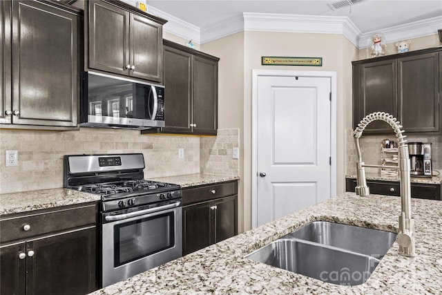 3835 Norman View Dr, Sherrills Ford, NC 28673 - kitchen featuring appliances with stainless steel finishes, backsplash, ornamental molding, light stone countertops, and dark brown cabinetry