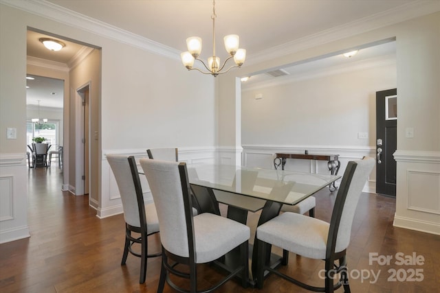 12704 Franklin Square Rd, Charlotte, NC 28213 - dining space featuring a chandelier, dark wood-style flooring, a wainscoted wall, ornamental molding, and a decorative wall