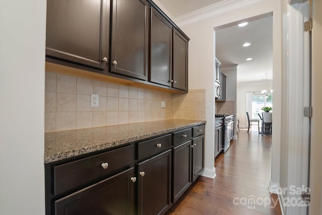 12704 Franklin Square Rd, Charlotte, NC 28213 - kitchen with ornamental molding, dark stone countertops, dark brown cabinetry, tasteful backsplash, and stainless steel stove