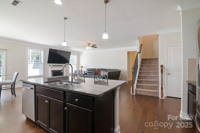 12704 Franklin Square Rd, Charlotte, NC 28213 - kitchen with ornamental molding, a fireplace, stainless steel dishwasher, dark wood-style flooring, and dark stone countertops