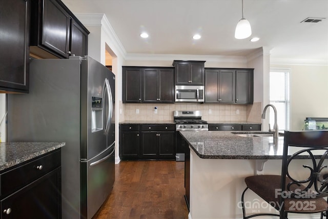 12704 Franklin Square Rd, Charlotte, NC 28213 - kitchen with stainless steel appliances, dark wood-style flooring, ornamental molding, dark stone countertops, and a kitchen breakfast bar