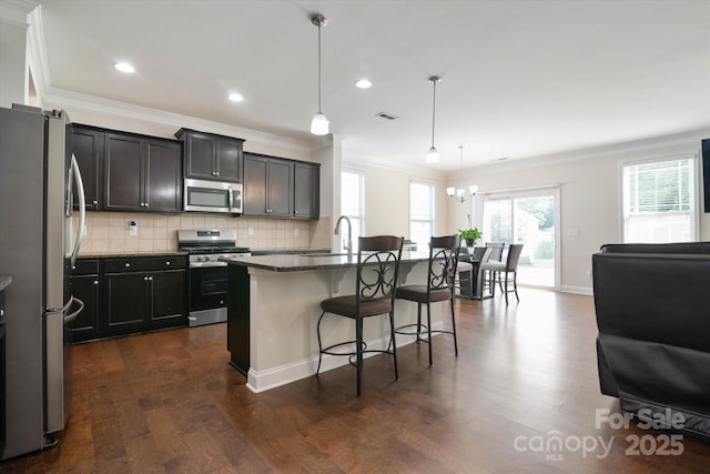 12704 Franklin Square Rd, Charlotte, NC 28213 - kitchen with stainless steel appliances, a breakfast bar area, ornamental molding, open floor plan, and dark wood-type flooring