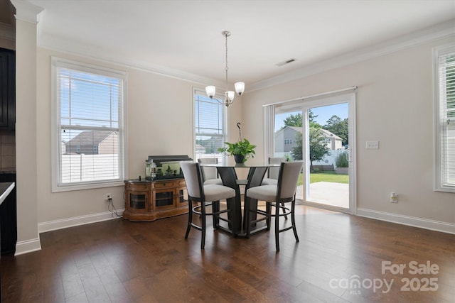 12704 Franklin Square Rd, Charlotte, NC 28213 - dining area featuring healthy amount of natural light, a chandelier, crown molding, and dark wood-style floors