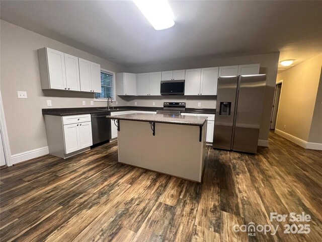 507 Putter Pl, Chester, SC 29706 - kitchen with stainless steel appliances, dark wood finished floors, a kitchen island, and white cabinets