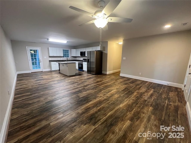 507 Putter Pl, Chester, SC 29706 - kitchen with appliances with stainless steel finishes, open floor plan, dark wood-type flooring, ceiling fan, and white cabinetry