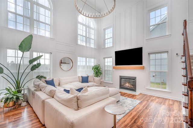 2380 Fairport Dr SE, Concord, NC 28025 - living room featuring a high ceiling, wood finished floors, and a glass covered fireplace