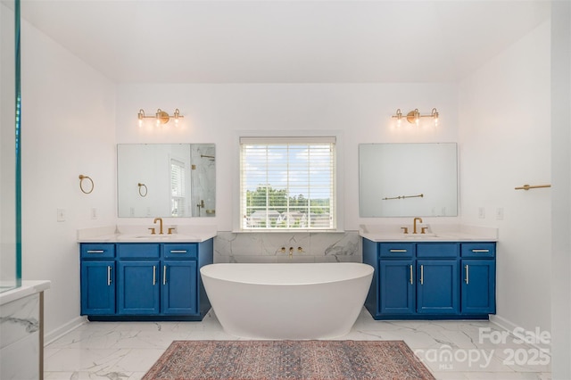 2380 Fairport Dr SE, Concord, NC 28025 - bathroom featuring marble look tile flooring, two vanities, and a soaking tub