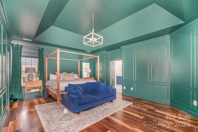 2380 Fairport Dr SE, Concord, NC 28025 - bedroom with a decorative wall, a chandelier, and dark wood-style flooring