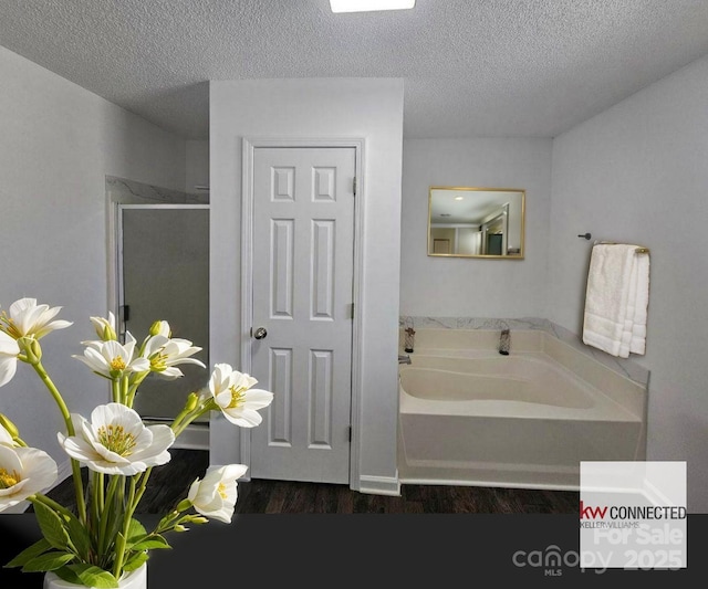 11 Long Glen Ct Unit 113, Columbia, SC 29229 - bathroom featuring a garden tub, a textured ceiling, wood finished floors, and a shower stall