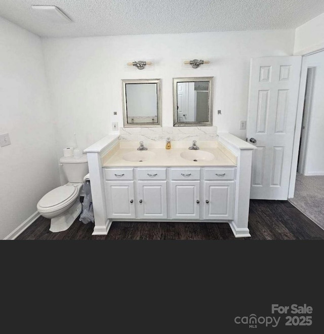 11 Long Glen Ct Unit 113, Columbia, SC 29229 - bathroom featuring wood finished floors, double vanity, tasteful backsplash, and a textured ceiling