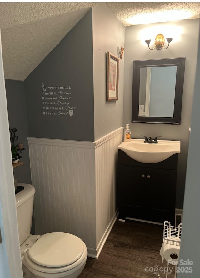 11 Long Glen Ct Unit 113, Columbia, SC 29229 - bathroom featuring a textured ceiling, wood finished floors, vanity, and wainscoting