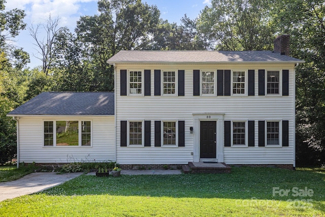 80 Lecline Cir NE, Concord, NC 28025 - colonial-style house with a chimney, a front yard, and roof with shingles