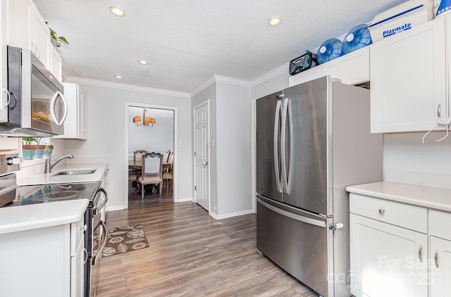 80 Lecline Cir NE, Concord, NC 28025 - kitchen with appliances with stainless steel finishes, white cabinets, light wood finished floors, light countertops, and crown molding