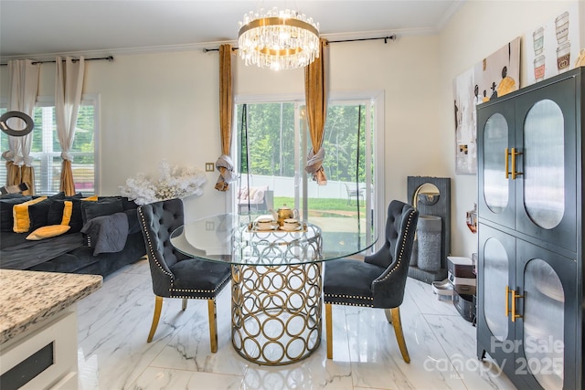 154 Tanner Loop, Troutman, NC 28166 - dining room featuring a chandelier, crown molding, plenty of natural light, and light marble finish floors