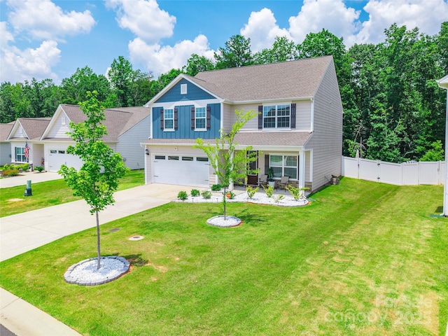 154 Tanner Loop, Troutman, NC 28166 - traditional-style house with concrete driveway, an attached garage, a gate, roof with shingles, and a porch
