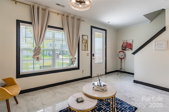 154 Tanner Loop, Troutman, NC 28166 - entryway featuring light marble finish floors, a chandelier, and crown molding