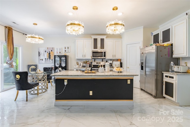 154 Tanner Loop, Troutman, NC 28166 - kitchen with appliances with stainless steel finishes, a chandelier, crown molding, white cabinetry, and glass insert cabinets