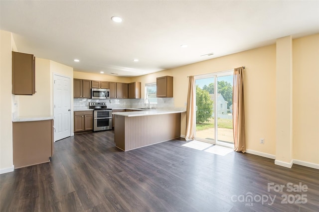 2357 Riding Trail Rd, Gastonia, NC 28054 - kitchen with stainless steel appliances, a peninsula, decorative backsplash, light countertops, and recessed lighting
