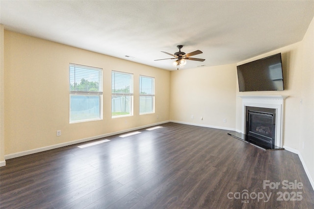 2357 Riding Trail Rd, Gastonia, NC 28054 - unfurnished living room featuring dark wood-style flooring, ceiling fan, and a glass covered fireplace