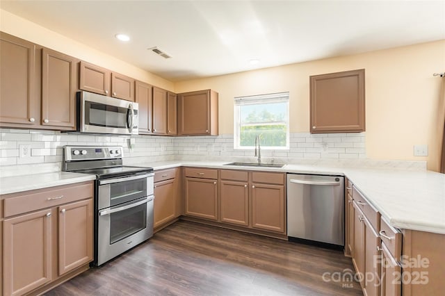 2357 Riding Trail Rd, Gastonia, NC 28054 - kitchen with stainless steel appliances, a peninsula, light countertops, decorative backsplash, and dark wood finished floors