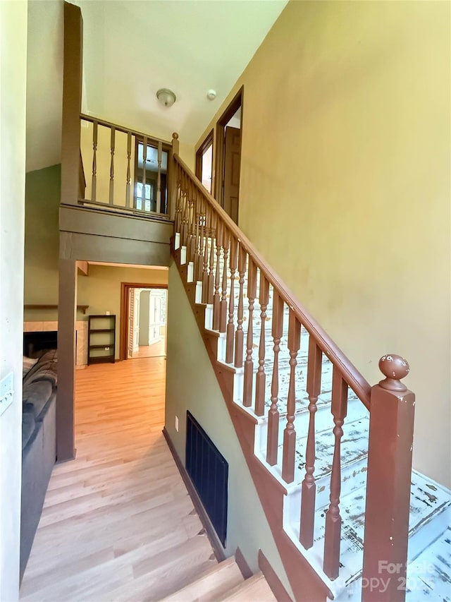 5685 Pine Ridge Dr, Connelly Springs, NC 28612 - staircase featuring wood finished floors, a towering ceiling, and healthy amount of natural light