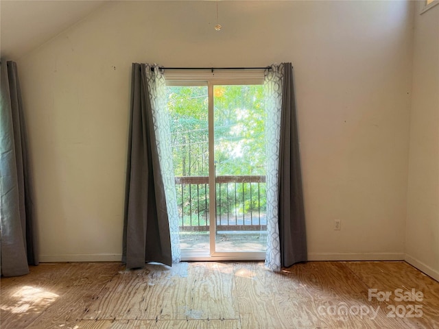 5685 Pine Ridge Dr, Connelly Springs, NC 28612 - empty room featuring plenty of natural light, wood finished floors, and vaulted ceiling