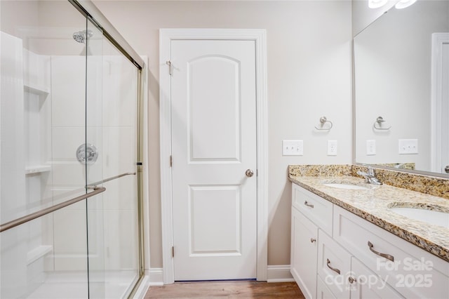 206 N Kayla Dr, Salisbury, NC 28146 - bathroom featuring a stall shower, double vanity, and wood finished floors