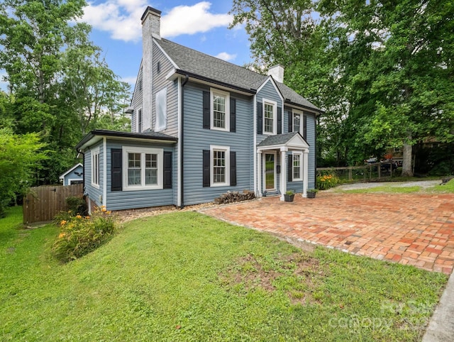 321 Ehringhaus St, Hendersonville, NC 28739 - colonial house featuring a chimney, a patio, and a shingled roof