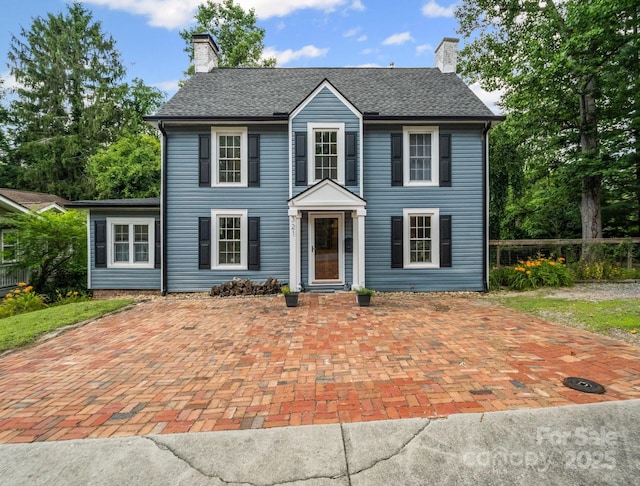 321 Ehringhaus St, Hendersonville, NC 28739 - colonial home featuring a chimney and roof with shingles