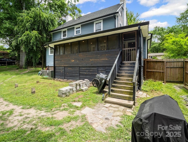 321 Ehringhaus St, Hendersonville, NC 28739 - view of front of house with a chimney, a sunroom, stairway, and board and batten siding