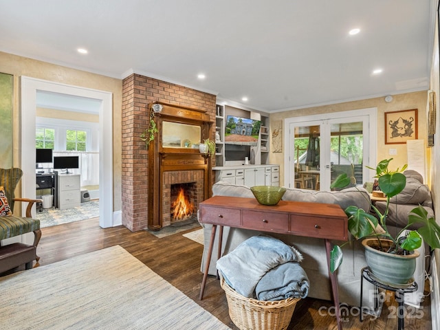 321 Ehringhaus St, Hendersonville, NC 28739 - living room with french doors, a brick fireplace, plenty of natural light, dark wood-style floors, and crown molding