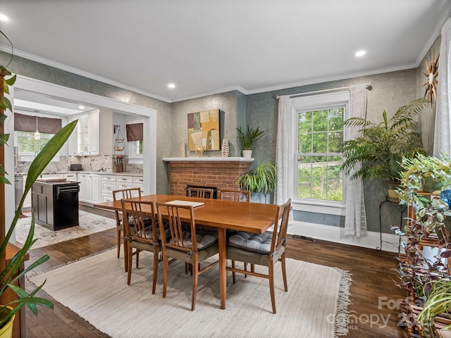 321 Ehringhaus St, Hendersonville, NC 28739 - dining area with crown molding, plenty of natural light, dark wood-type flooring, a brick fireplace, and recessed lighting