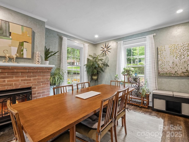321 Ehringhaus St, Hendersonville, NC 28739 - dining area with wood finished floors, crown molding, plenty of natural light, a brick fireplace, and recessed lighting