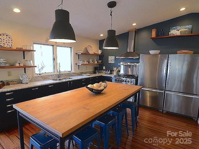 617 Norton Fork Rd, Hot Springs, NC 28743 - kitchen featuring open shelves, wall chimney range hood, dark cabinetry, freestanding refrigerator, and dark wood-style floors