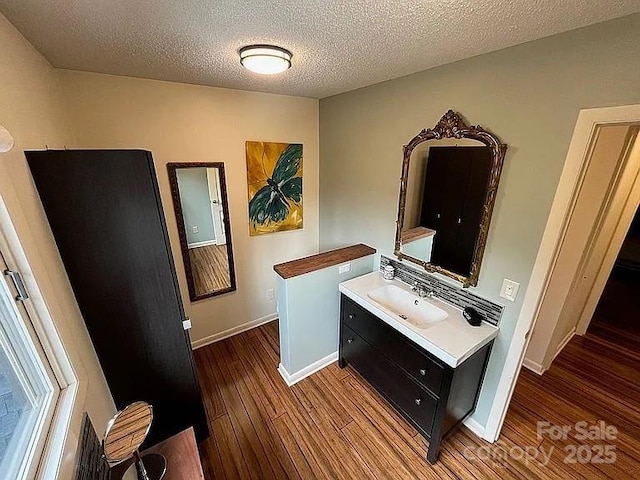 617 Norton Fork Rd, Hot Springs, NC 28743 - bathroom featuring wood finished floors, vanity, and a textured ceiling