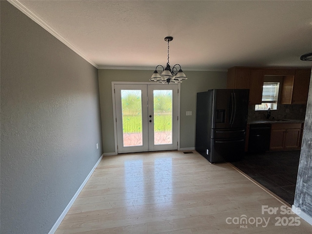 72 Helens Way, Taylorsville, NC 28681 - unfurnished dining area featuring a chandelier, light wood finished floors, ornamental molding, a textured wall, and french doors