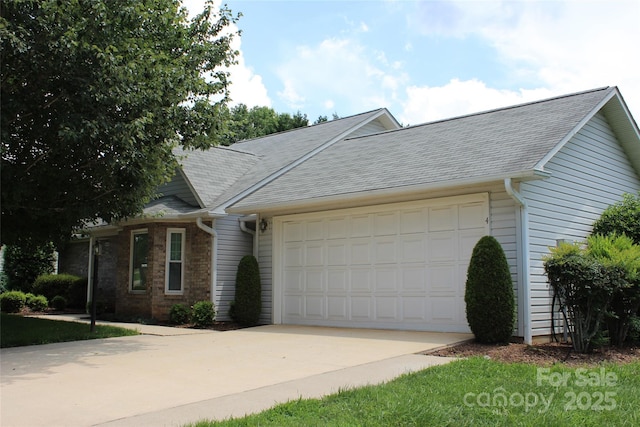 4 Gatehouse Ct, Asheville, NC 28803 - view of property featuring driveway, an attached garage, and roof with shingles